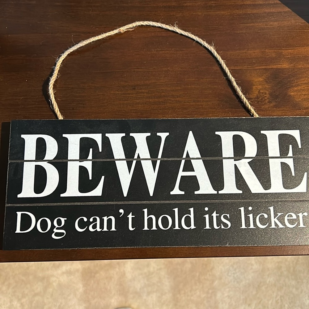 Hanging sign beware dog can’t hold it’s licker
